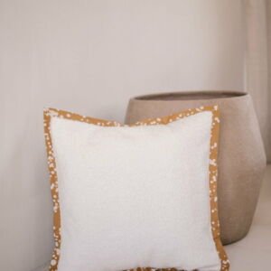 Cushion cover with a batik trim and white boucle velvet
