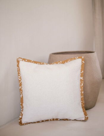 Cushion cover with a batik trim and white boucle velvet